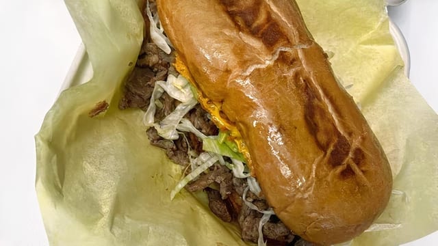 Asada Torta - Beans, Cheese, Guacamole, Lettuce, Carne Asada, Salsa Fresca.