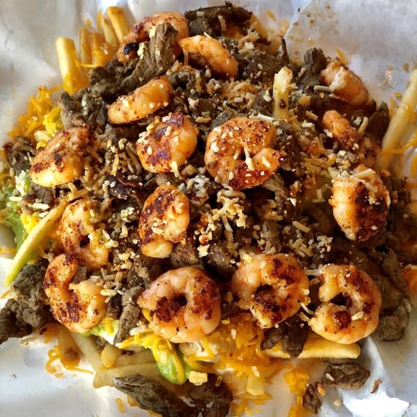 Roberto's Taco Shop's carne asada fries with grilled shrimp, cheese, and avocado.
